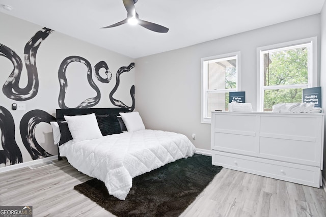 bedroom featuring light hardwood / wood-style flooring and ceiling fan