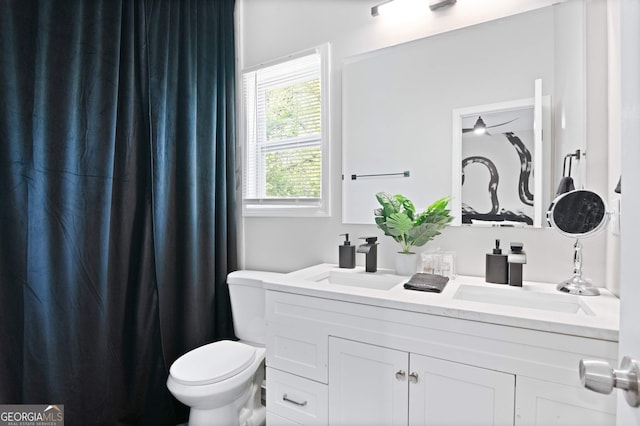 bathroom featuring vanity and toilet