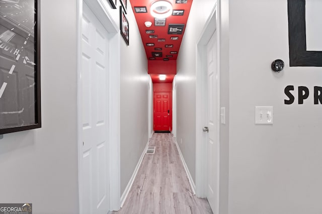 hallway with light hardwood / wood-style floors