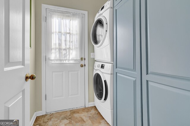 laundry room featuring stacked washer and clothes dryer