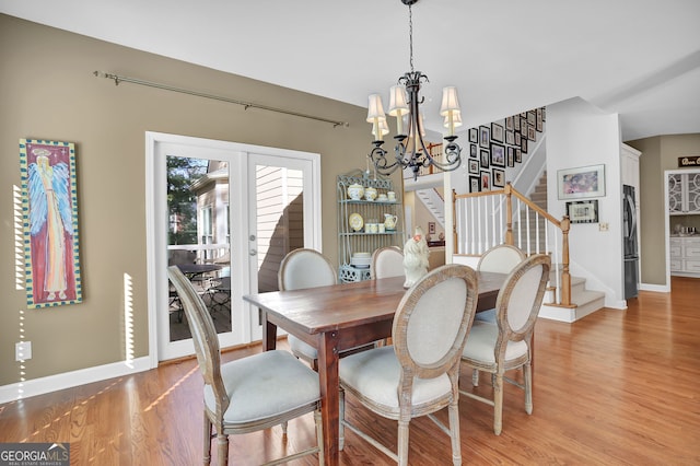 dining room with a notable chandelier and light hardwood / wood-style flooring