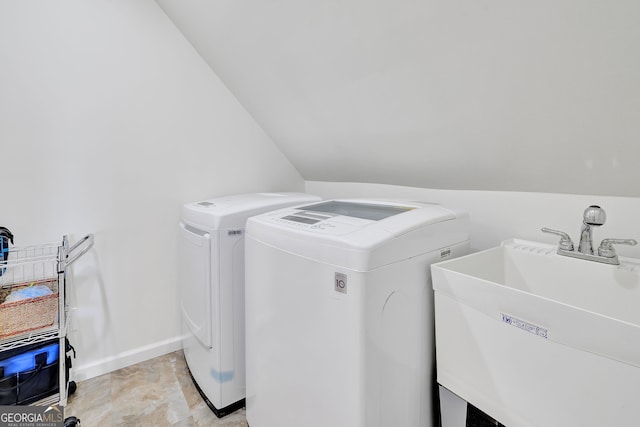 laundry room featuring washing machine and clothes dryer and sink