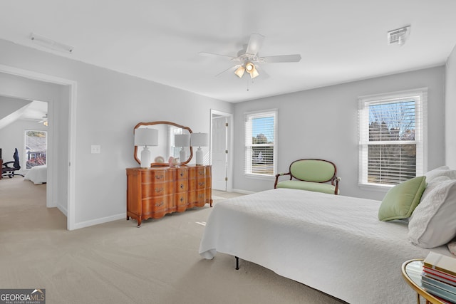 bedroom featuring multiple windows, ceiling fan, and light colored carpet