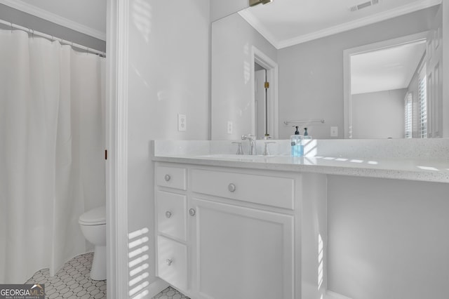 bathroom featuring tile patterned flooring, vanity, toilet, and ornamental molding