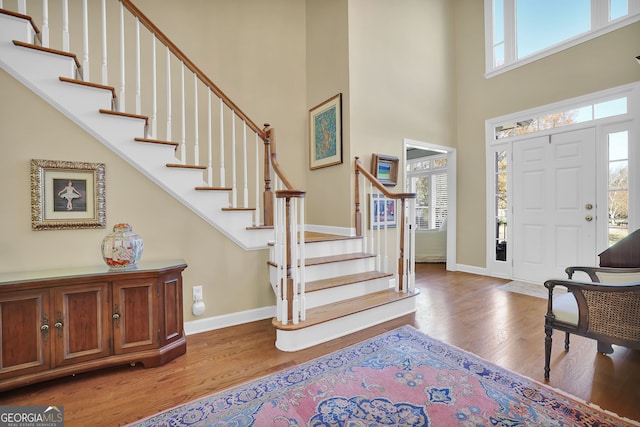 foyer with light hardwood / wood-style floors and a high ceiling