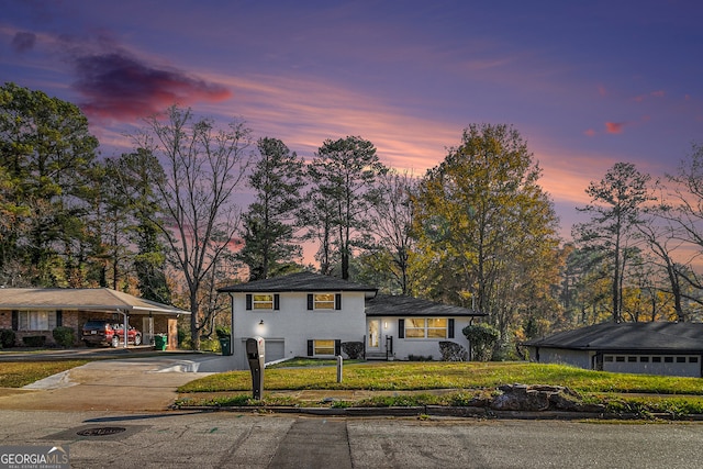 tri-level home featuring a yard and a carport