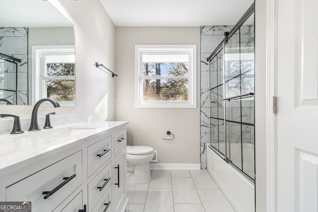 full bathroom with vanity, combined bath / shower with glass door, and toilet