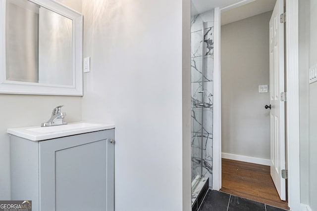 bathroom with a shower, vanity, and hardwood / wood-style flooring