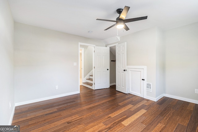 unfurnished bedroom featuring dark hardwood / wood-style flooring and ceiling fan