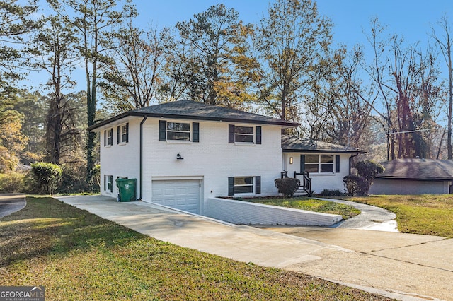 split level home featuring a garage and a front lawn