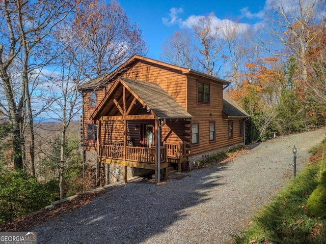 log home featuring a wooden deck