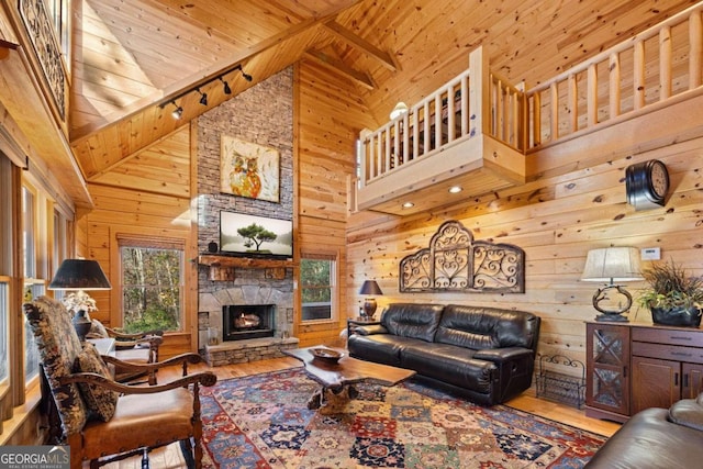 living room featuring wood-type flooring, high vaulted ceiling, and wooden ceiling