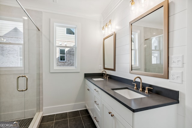 bathroom with tile patterned flooring, vanity, a shower with shower door, and ornamental molding