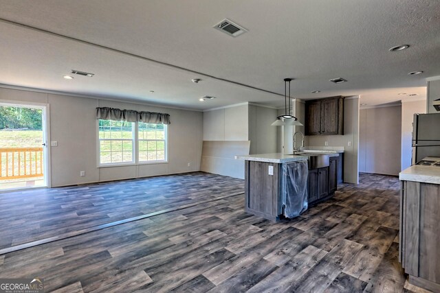 laundry room featuring a textured ceiling, dark wood-type flooring, and hookup for a washing machine