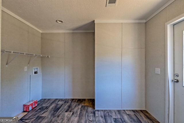 laundry room featuring washer hookup, dark hardwood / wood-style floors, and a textured ceiling