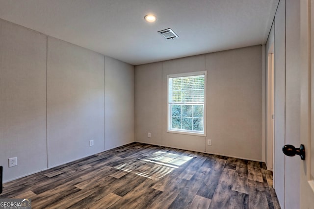 unfurnished room with dark hardwood / wood-style floors