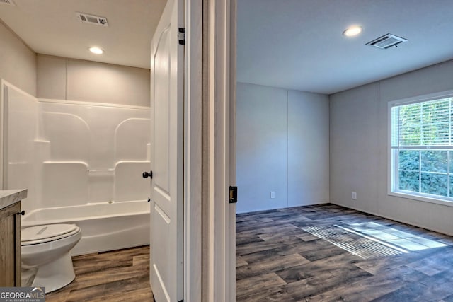 full bathroom with vanity, hardwood / wood-style floors, toilet, and shower / bath combination