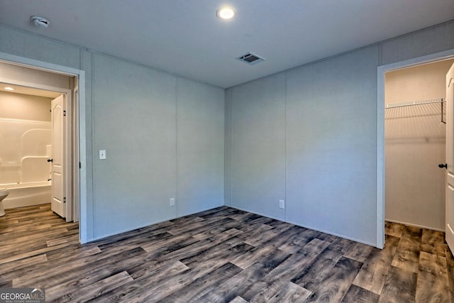 unfurnished bedroom with dark hardwood / wood-style floors