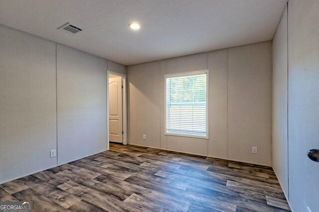 back of property with a wooden deck and central AC