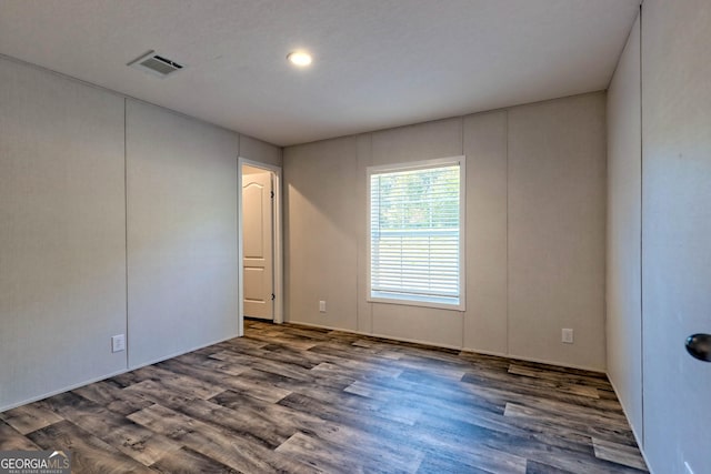 spare room with dark hardwood / wood-style flooring