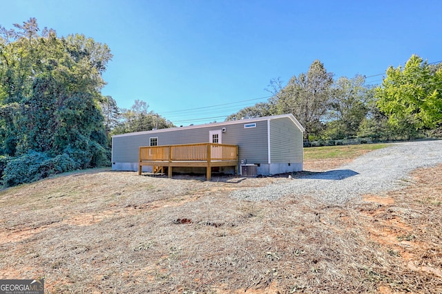 back of property with central air condition unit and a wooden deck