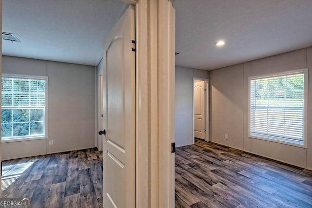 corridor with dark hardwood / wood-style flooring