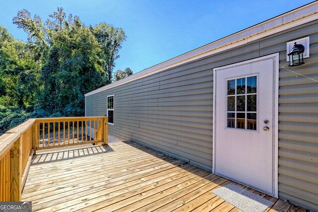 back of property with central air condition unit and a wooden deck