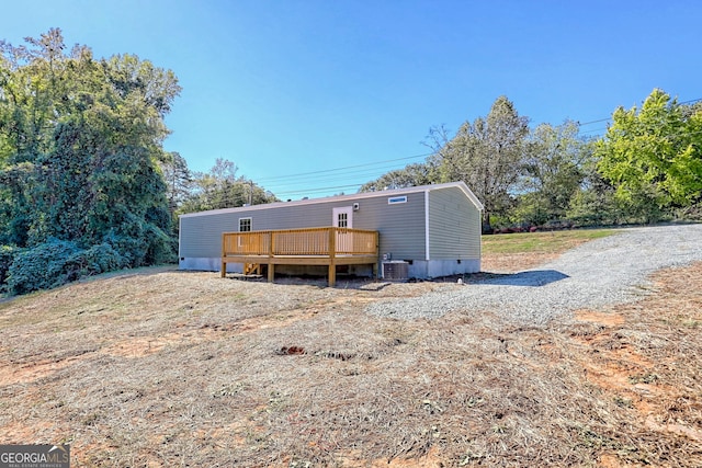 rear view of house featuring central AC unit and a deck