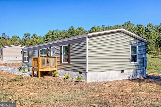 back of house featuring central AC unit and a deck