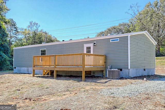 rear view of house with a wooden deck and central AC