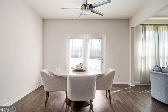 dining space featuring ceiling fan and dark wood-type flooring