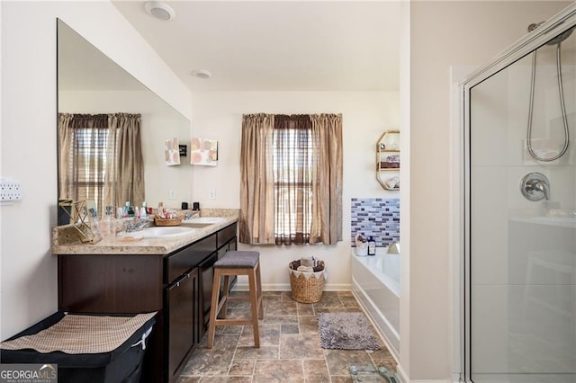 bathroom featuring vanity and shower with separate bathtub