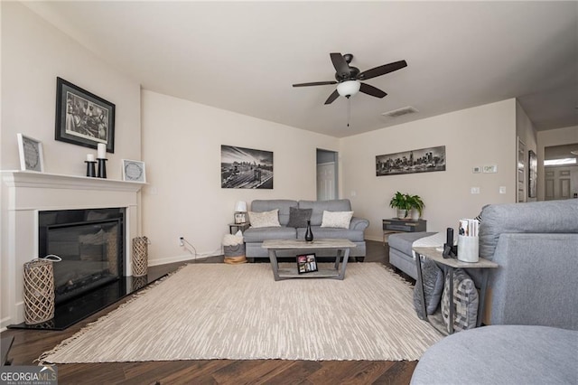 living room featuring hardwood / wood-style flooring and ceiling fan