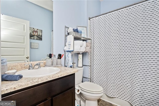 bathroom with curtained shower, vanity, and toilet