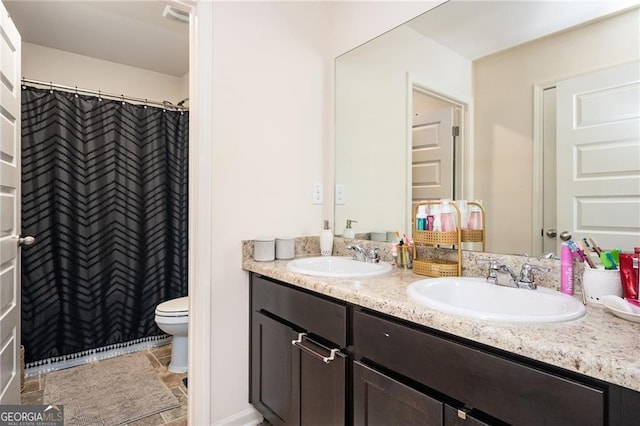 bathroom featuring vanity and toilet