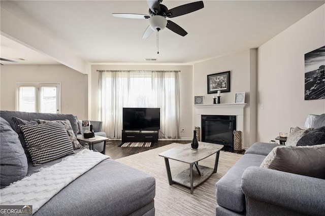 living room with wood-type flooring and ceiling fan