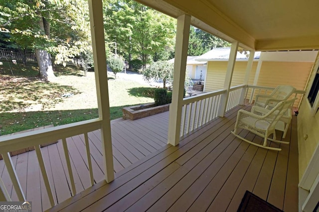 wooden deck with a lawn