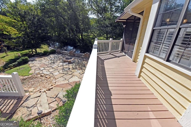 view of patio with a deck and an outdoor fire pit