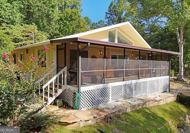 back of house featuring a sunroom