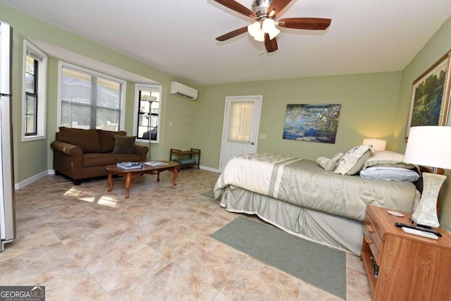 bedroom with ceiling fan and an AC wall unit