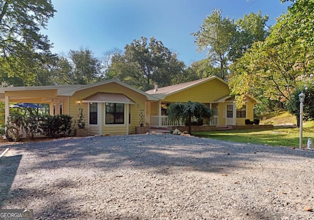 single story home featuring a carport