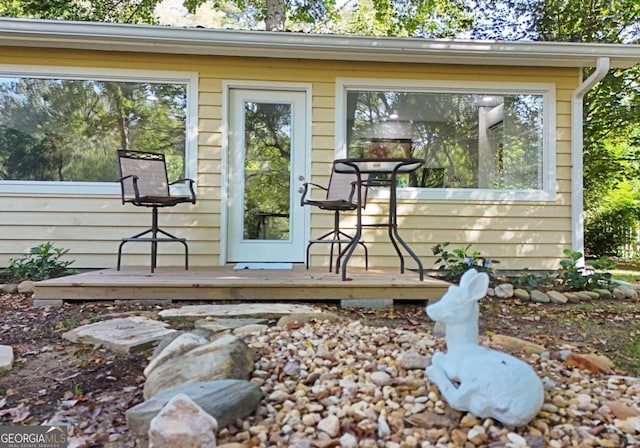 view of exterior entry featuring a wooden deck