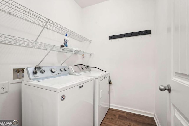 clothes washing area featuring dark hardwood / wood-style floors and washing machine and dryer