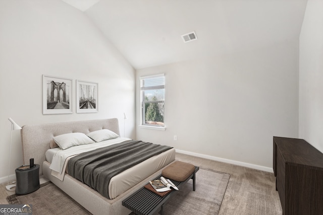 carpeted bedroom with lofted ceiling