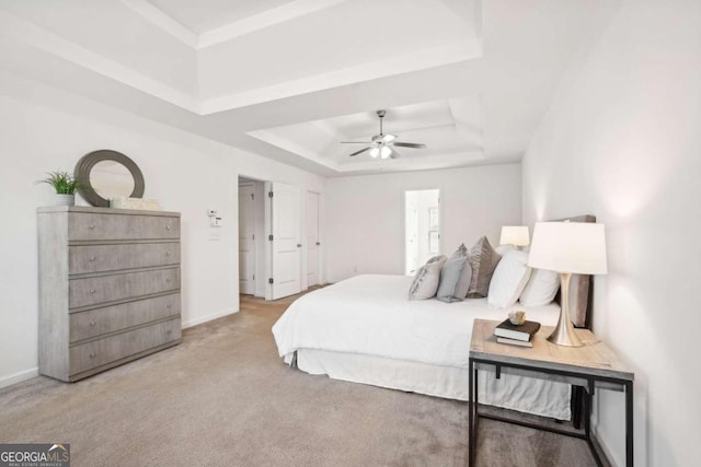 bedroom featuring a tray ceiling, ceiling fan, and light colored carpet