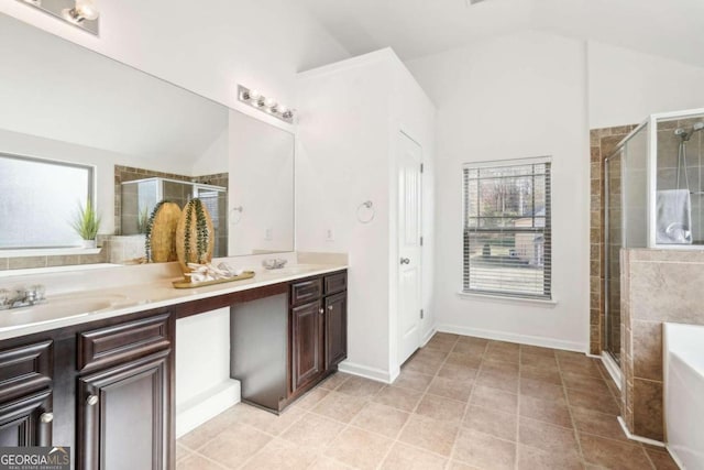 bathroom featuring vanity, a wealth of natural light, and lofted ceiling