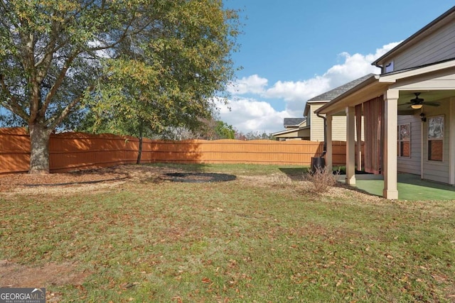 view of yard with ceiling fan and a patio area