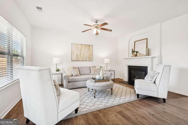 living room featuring wood-type flooring and ceiling fan