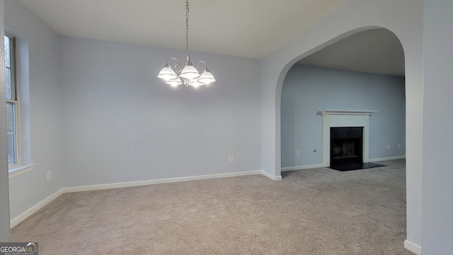 interior space with light carpet and a notable chandelier