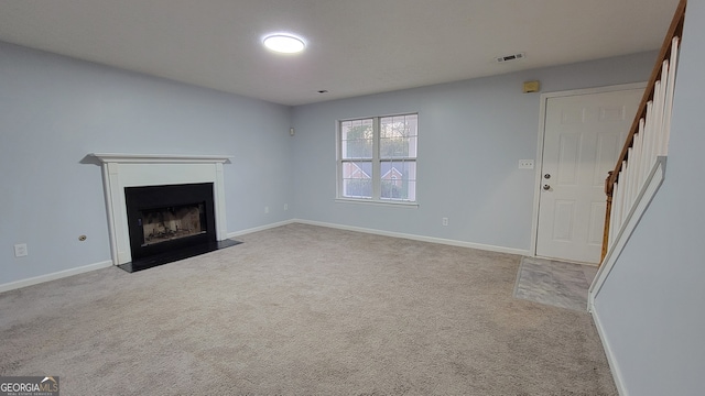 unfurnished living room featuring light colored carpet